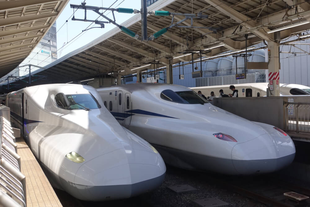 Two Shinkansen trains waiting to depart.