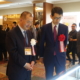 Here, the President of the Japan Dealers Association guides the Director of Japan Mint through the numismatic exhibition.